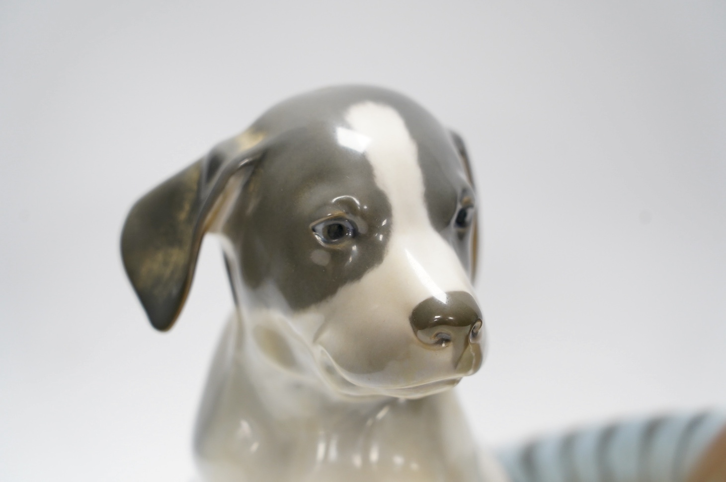 A Royal Copenhagen puppy, 20cm high, and a pheasant. Condition - good
